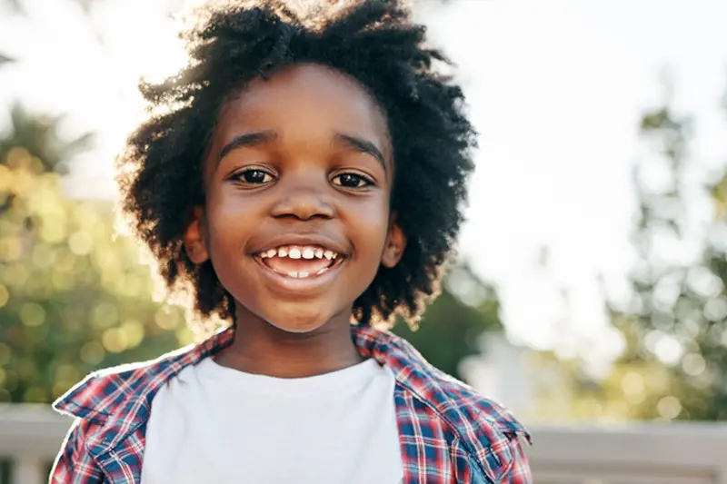 Joyful kid enjoying sunny day
