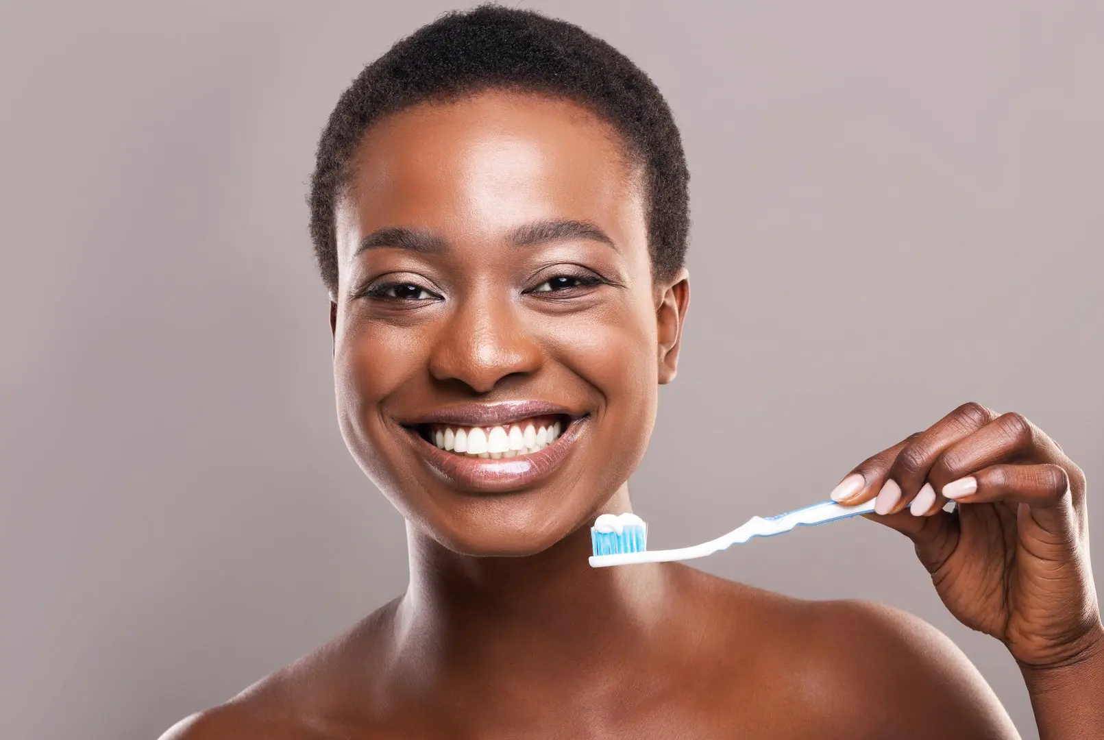 Happy person showing toothbrush close-up