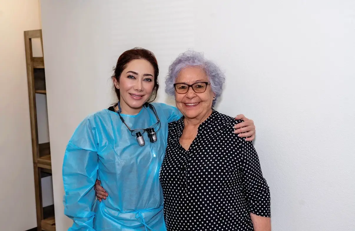 Two women standing next to each other in a room