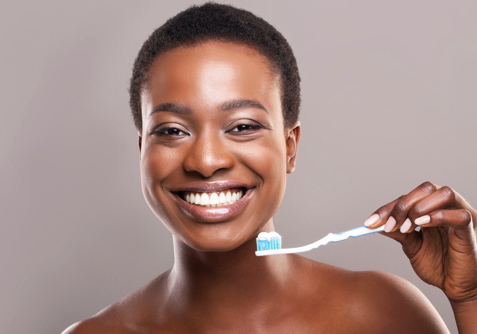 Happy person showing toothbrush close-up